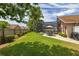 Wide-open backyard with a screen enclosed pool, manicured landscaping, and mature trees at 239 King George Dr, Davenport, FL 33837