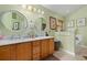 Bathroom features double sinks, a large counter, and a built-in tub and is lit by overhead lighting at 239 King George Dr, Davenport, FL 33837