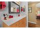 Bathroom with marble countertop, wood cabinets, and decor accents at 239 King George Dr, Davenport, FL 33837