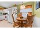 Breakfast nook connected to kitchen featuring wood table, chairs, and view from large window at 239 King George Dr, Davenport, FL 33837