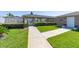The community pool area, showcasing lush landscaping and a well-maintained walkway at 239 King George Dr, Davenport, FL 33837