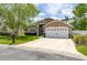 Charming single-Gathering home features a well-manicured lawn and two car garage at 239 King George Dr, Davenport, FL 33837
