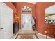 Inviting foyer featuring tile flooring, decorative rug, and an ornate glass front door at 239 King George Dr, Davenport, FL 33837