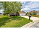 Charming single-story home with a well-manicured lawn, mature tree, and inviting two-car garage at 239 King George Dr, Davenport, FL 33837