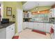Bright kitchen featuring tile backsplash, white cabinets, and modern appliances at 239 King George Dr, Davenport, FL 33837