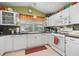 Bright kitchen with white cabinetry, tile backsplash, and modern appliances at 239 King George Dr, Davenport, FL 33837