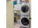 Laundry room features stacked washer and dryer, cabinets, and counter for folding at 239 King George Dr, Davenport, FL 33837