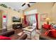 Cozy living room features hardwood floors, a view of the lanai and a comfortable seating arrangement at 239 King George Dr, Davenport, FL 33837