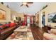 Spacious living room boasts hardwood floors, comfortable leather seating, and an inviting atmosphere at 239 King George Dr, Davenport, FL 33837