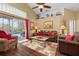Inviting living room with hardwood floors, comfortable seating, and a view of the outdoor pool area at 239 King George Dr, Davenport, FL 33837