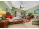 This main bedroom features a ceiling fan, a sliding door to the lanai and outdoor pool at 239 King George Dr, Davenport, FL 33837