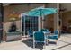 View of an outdoor patio area with a table, chairs, and umbrella, ideal for enjoying a meal at 239 King George Dr, Davenport, FL 33837
