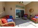 Cozy covered patio features comfortable seating and a sliding glass door, perfect for relaxation at 239 King George Dr, Davenport, FL 33837