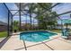Sparkling screened-in pool with a sun deck and blue tile; the perfect backyard oasis at 239 King George Dr, Davenport, FL 33837