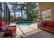 Relax in this screened pool area, featuring comfortable seating and a refreshing swimming pool at 239 King George Dr, Davenport, FL 33837