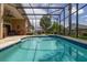 Beautiful screened-in pool featuring outdoor seating and a well-maintained, lush lawn at 239 King George Dr, Davenport, FL 33837