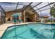 Beautiful screened-in pool area perfect for entertaining or relaxing by the pristine pool at 239 King George Dr, Davenport, FL 33837