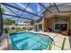 Stunning screened-in pool with outdoor dining and seating areas perfect for entertaining in style at 239 King George Dr, Davenport, FL 33837
