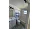 Bright bathroom features a shower-tub combo, white vanity, and tiled floor at 2451 Quail Run N Blvd, Kissimmee, FL 34744