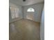 Empty bedroom with two windows allowing natural light, and tiled flooring at 2451 Quail Run N Blvd, Kissimmee, FL 34744