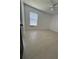 Bright bedroom with vaulted ceilings and tile flooring and a window at 2451 Quail Run N Blvd, Kissimmee, FL 34744