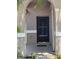 Close-up of the front door showing the decorative screen and arched entry at 2451 Quail Run N Blvd, Kissimmee, FL 34744