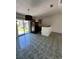 Open-concept living area with tile flooring, sliding glass doors, and a breakfast bar at 2451 Quail Run N Blvd, Kissimmee, FL 34744