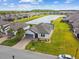Stunning aerial view of the well-manicured home, pond, and neighborhood at 249 Bella Cortina Dr, Kissimmee, FL 34759
