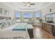Bright main bedroom suite features large windows and tray ceilings; inviting natural light and stylish design at 249 Bella Cortina Dr, Kissimmee, FL 34759
