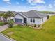 Beautiful exterior of a one-story home with a two car garage and well-manicured lawn at 249 Bella Cortina Dr, Kissimmee, FL 34759