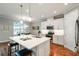 Open concept eat-in kitchen with stainless steel appliances and hardwood flooring at 249 Bella Cortina Dr, Kissimmee, FL 34759