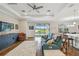 Comfortable living room with hardwood floors, ceiling fan, and sliding glass doors to the pool at 249 Bella Cortina Dr, Kissimmee, FL 34759