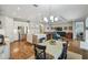 Open concept living space featuring modern kitchen with stainless appliances, a dining area, and a living room at 249 Bella Cortina Dr, Kissimmee, FL 34759