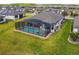 Aerial view of a private screened-in pool and spa, perfect for relaxation and entertainment at 249 Bella Cortina Dr, Kissimmee, FL 34759