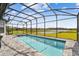 Sparkling pool with spa and screened enclosure overlooking the serene lake and community at 249 Bella Cortina Dr, Kissimmee, FL 34759