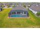 Aerial view of a private screened-in pool and spa, perfect for relaxation and entertainment at 249 Bella Cortina Dr, Kissimmee, FL 34759