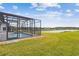 Enjoy a screened-in pool with a peaceful view of the adjacent water and community at 249 Bella Cortina Dr, Kissimmee, FL 34759