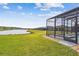 Relax and unwind in this screened-in pool with a tranquil view of the lake at 249 Bella Cortina Dr, Kissimmee, FL 34759