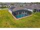 Aerial view of a private screened-in pool and spa, perfect for relaxation and entertainment at 249 Bella Cortina Dr, Kissimmee, FL 34759