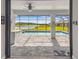 Covered screened-in patio with pavers surrounding a pool and spa overlooking a lake at 249 Bella Cortina Dr, Kissimmee, FL 34759