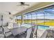 Screened in patio with a dining table and seating overlooking a pool, and water views at 249 Bella Cortina Dr, Kissimmee, FL 34759