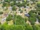 Aerial view of a home in a verdant neighborhood with a defined property line at 2560 Greenwood Dr, Kissimmee, FL 34744