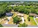 Aerial view of the property featuring mature trees and surrounding neighborhood at 2560 Greenwood Dr, Kissimmee, FL 34744
