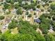 Real estate aerial showcasing the home's location within a lush, green community at 2560 Greenwood Dr, Kissimmee, FL 34744