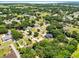 Wide aerial view showing homes in a green and spacious residential area near a lake at 2560 Greenwood Dr, Kissimmee, FL 34744