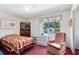 Inviting bedroom with window and comfortable armchair for relaxation at 2560 Greenwood Dr, Kissimmee, FL 34744