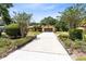 Home featuring a long driveway with mature landscaping at 2560 Greenwood Dr, Kissimmee, FL 34744