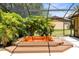 Outdoor hot tub on an elevated deck surrounded by lush tropical greenery at 2560 Greenwood Dr, Kissimmee, FL 34744