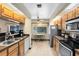 Galley kitchen with breakfast nook, tile floors, and wood cabinets provides a functional space at 2560 Greenwood Dr, Kissimmee, FL 34744