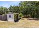 Backyard shed surrounded by grass and trees at 2560 Greenwood Dr, Kissimmee, FL 34744